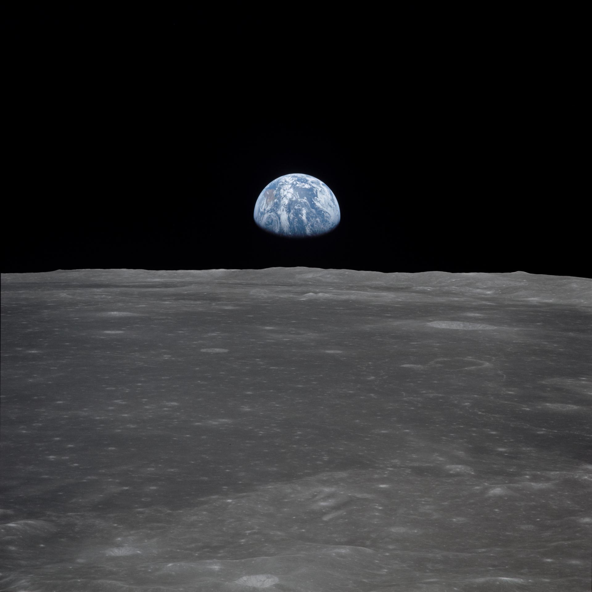 Earth rising above the lunar horizon